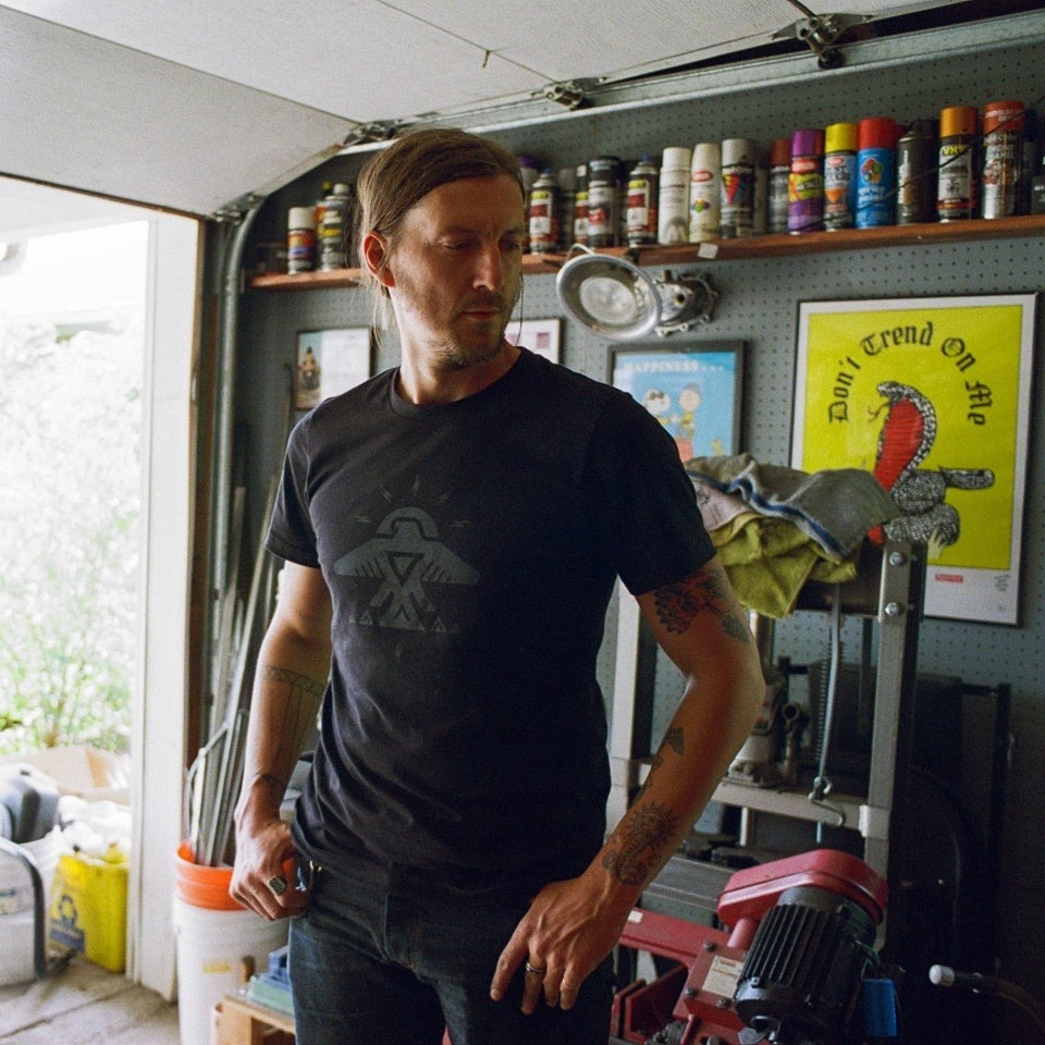 Made in USA Cotton thunderbird t-shirt by Indigenous Ginew on man working in garage
