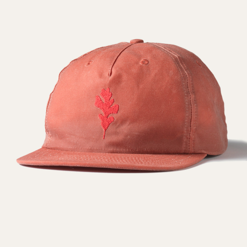 Front of Light red wax canvas hat with Native American oak leaf embroidered on front