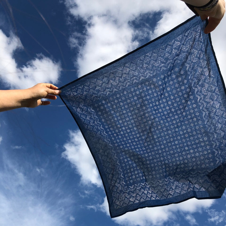 Ginew Medel made in USA hand rolled bandana all cotton in navy blowing in the wind