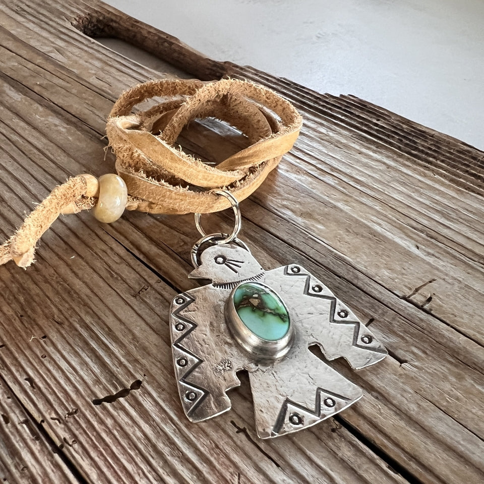 Close up of Hand made Native American Thunderbird Necklace with Turquoise