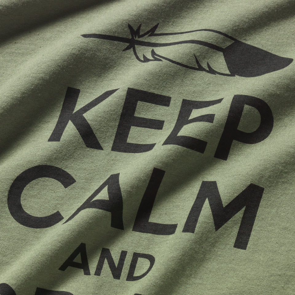 Close up of Green 100% all cotton t-shirt designed by Native American Ginew with keep calm and carry on text