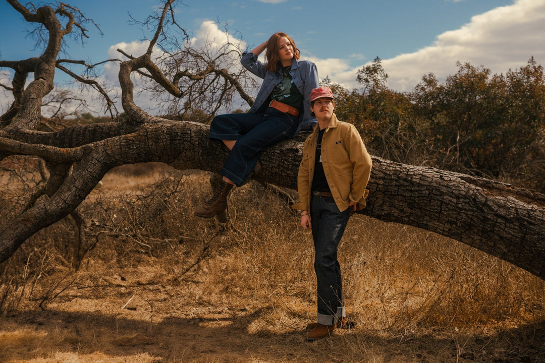 Blue and tan barn chore jacket on man and woman in field