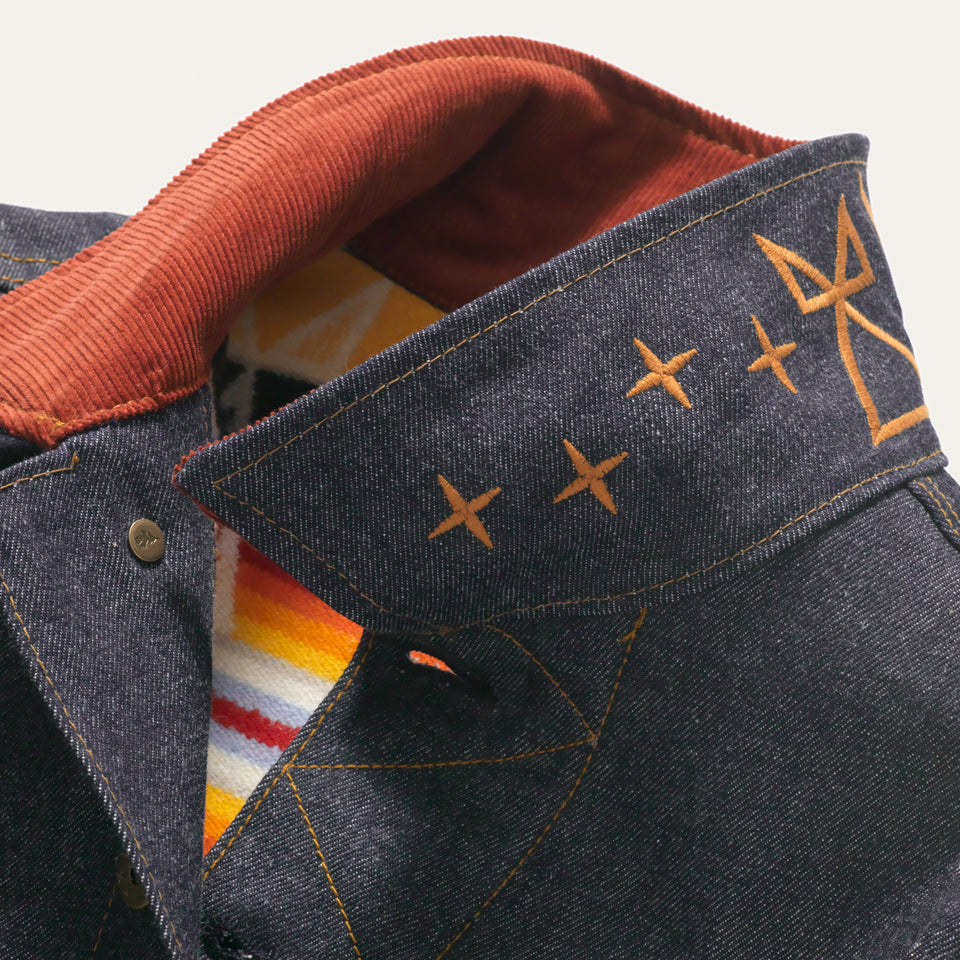 Corduroy collar with embroidery on Selvedge denim lined yellow coat with inside tag of Ginew Made in USA.