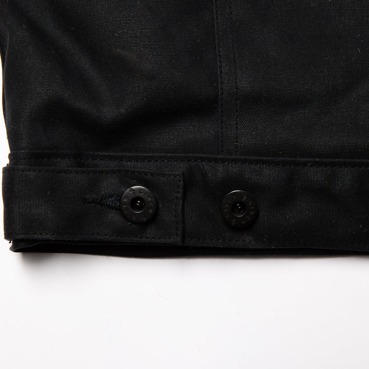  Detail view of custom hardware and adjustable button on back hem.