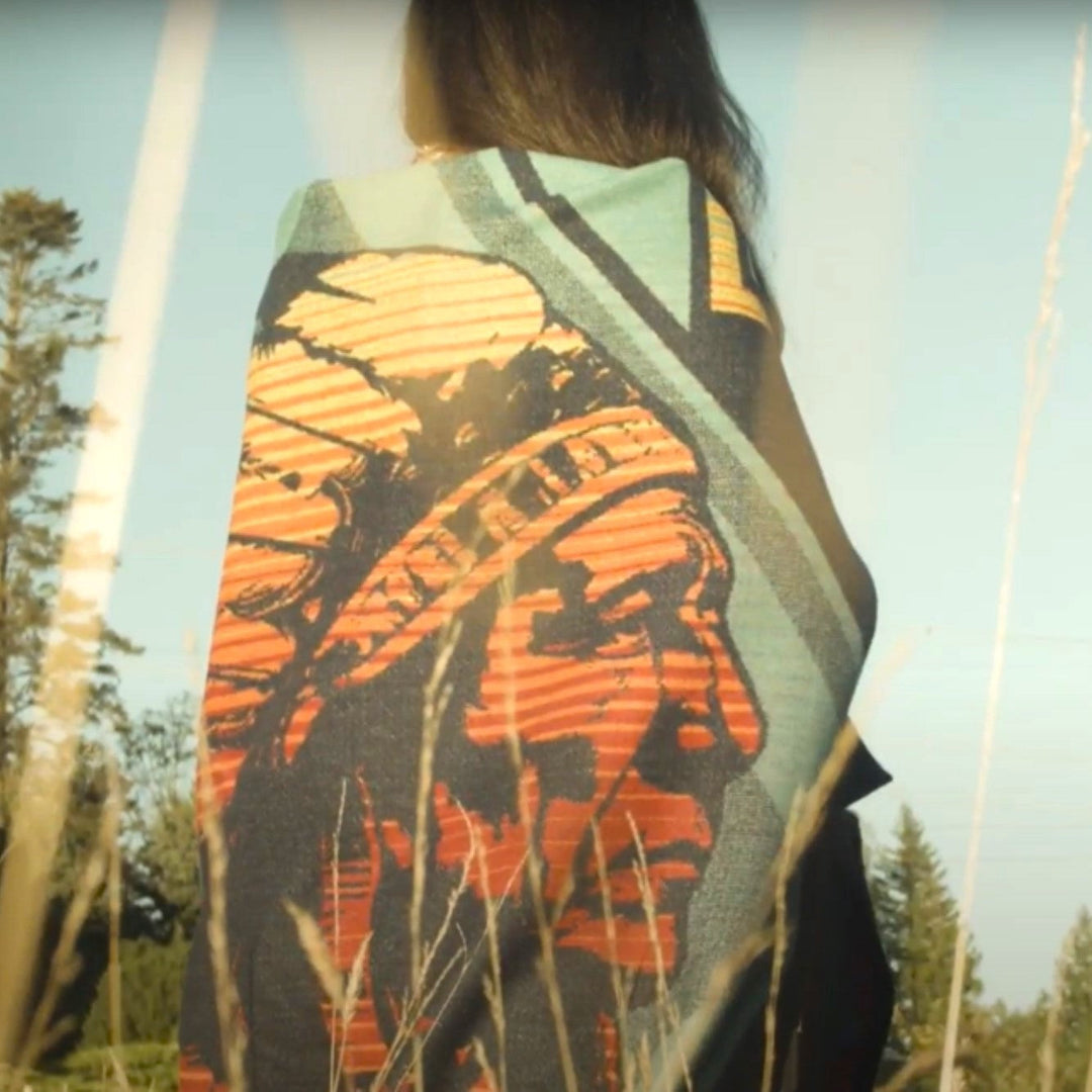 Colorful Wool cotton Sitting Bull Blanket on Native woman. Woven by Pendleton and designed by Native American Steven Paul Judd. 