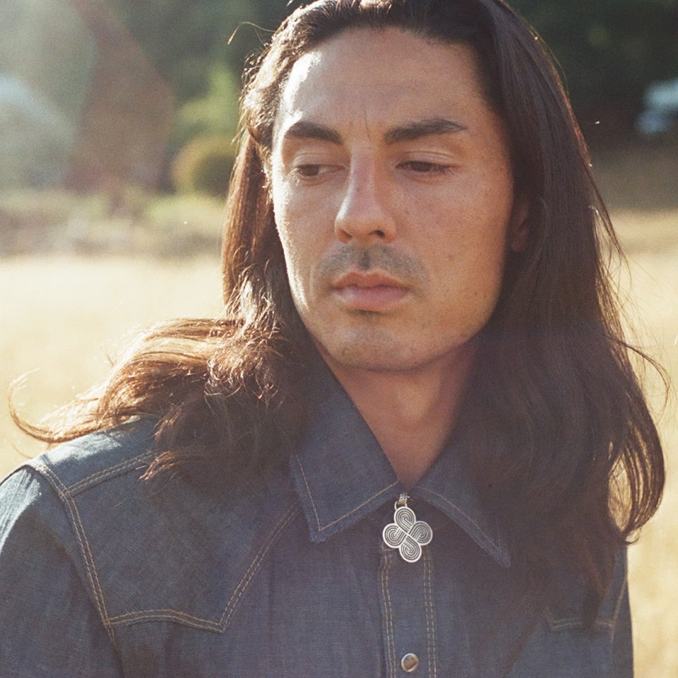 Native American man wearing Native designed and hand made Four Direction necklace