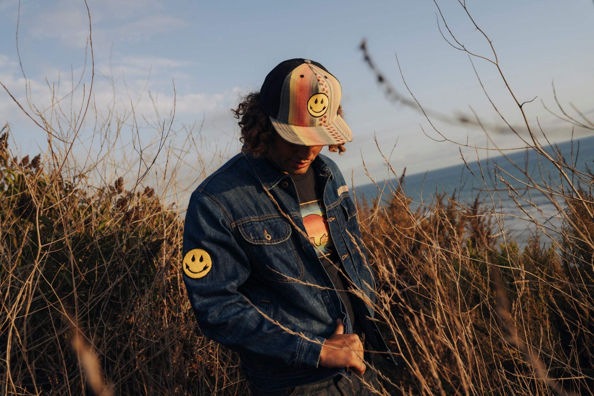 Woman and man wearing distress deadstock denim jacket customized by Steven Paul Judd with Native American designed patches