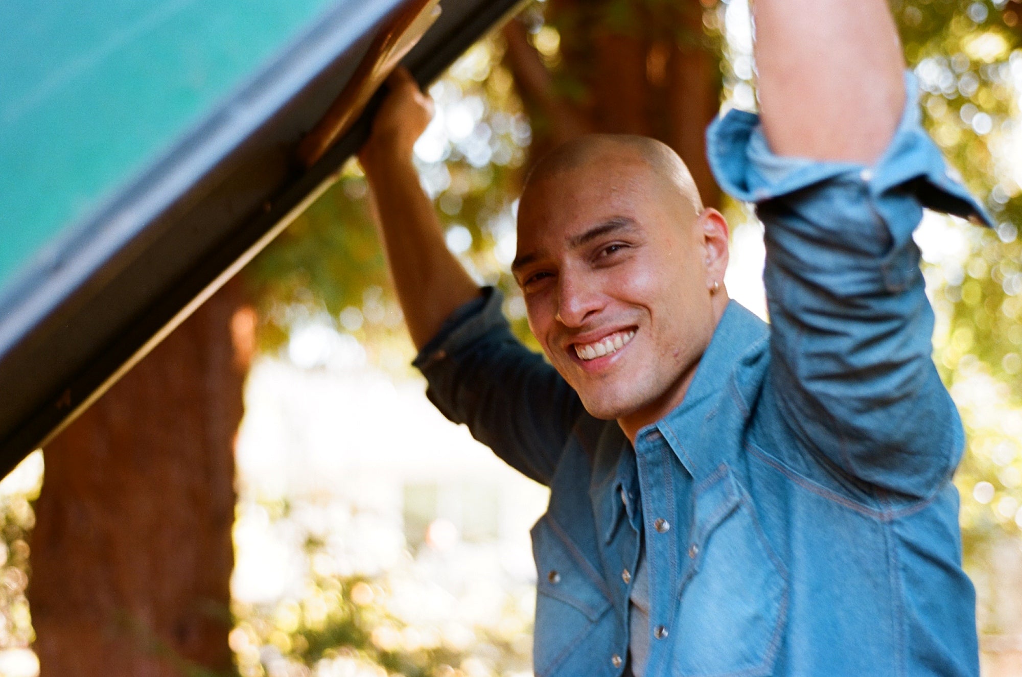 Native American in Ginew western shirt holding canoe