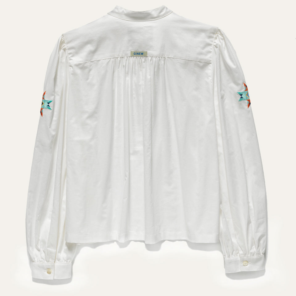 Back of Women’s longsleeve White peasant style shirt with Native American embroidery and Ginew tag