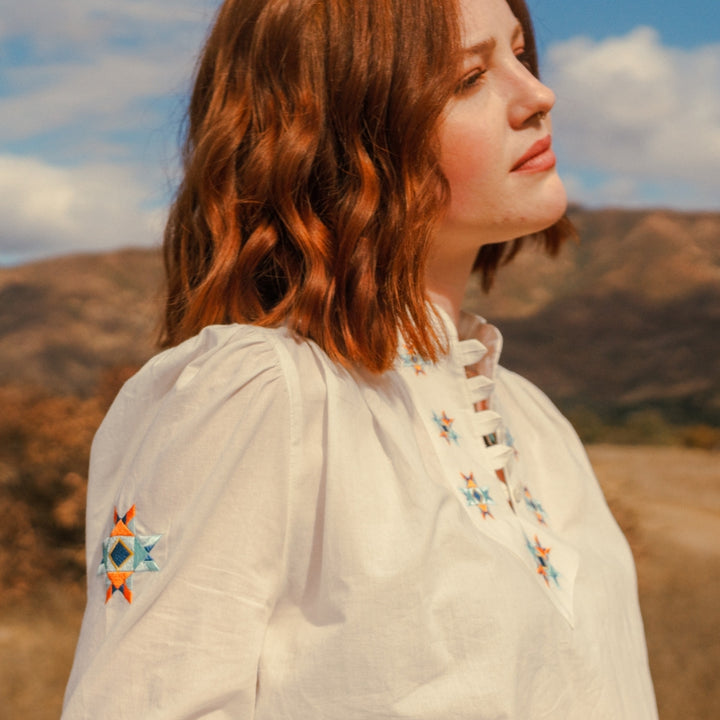 Cotton peasant style blouse with Native Americana embroidery on women in canyon