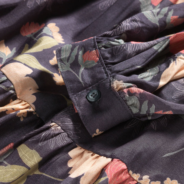 Close up of Bishop sleeve on Raw silk dress with flower print and ruffles. 