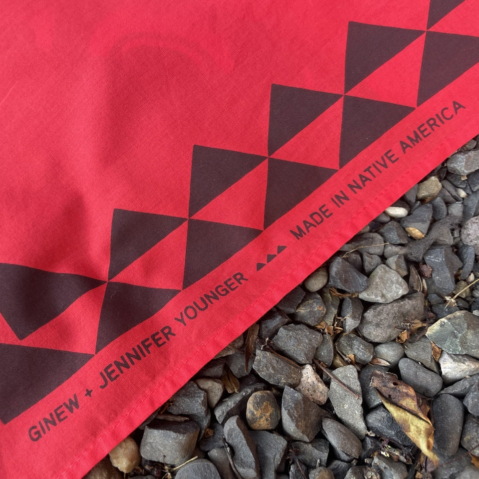Close up of Ginew + Jennifer Younger text on Native American designed Raven bandana in cotton and made in USA by Ginew 