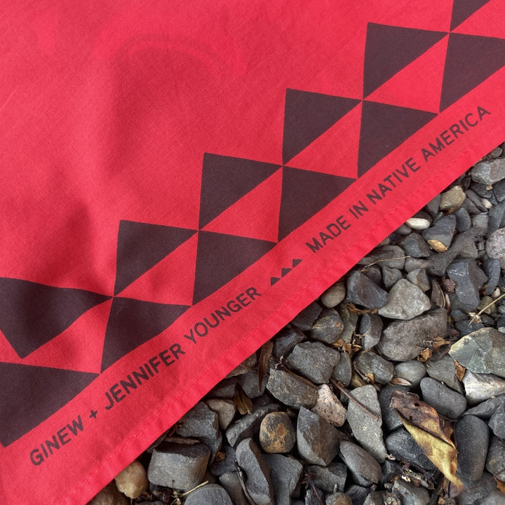 Close up of Ginew + Jennifer Younger text on Native American designed Raven bandana in cotton and made in USA by Ginew 