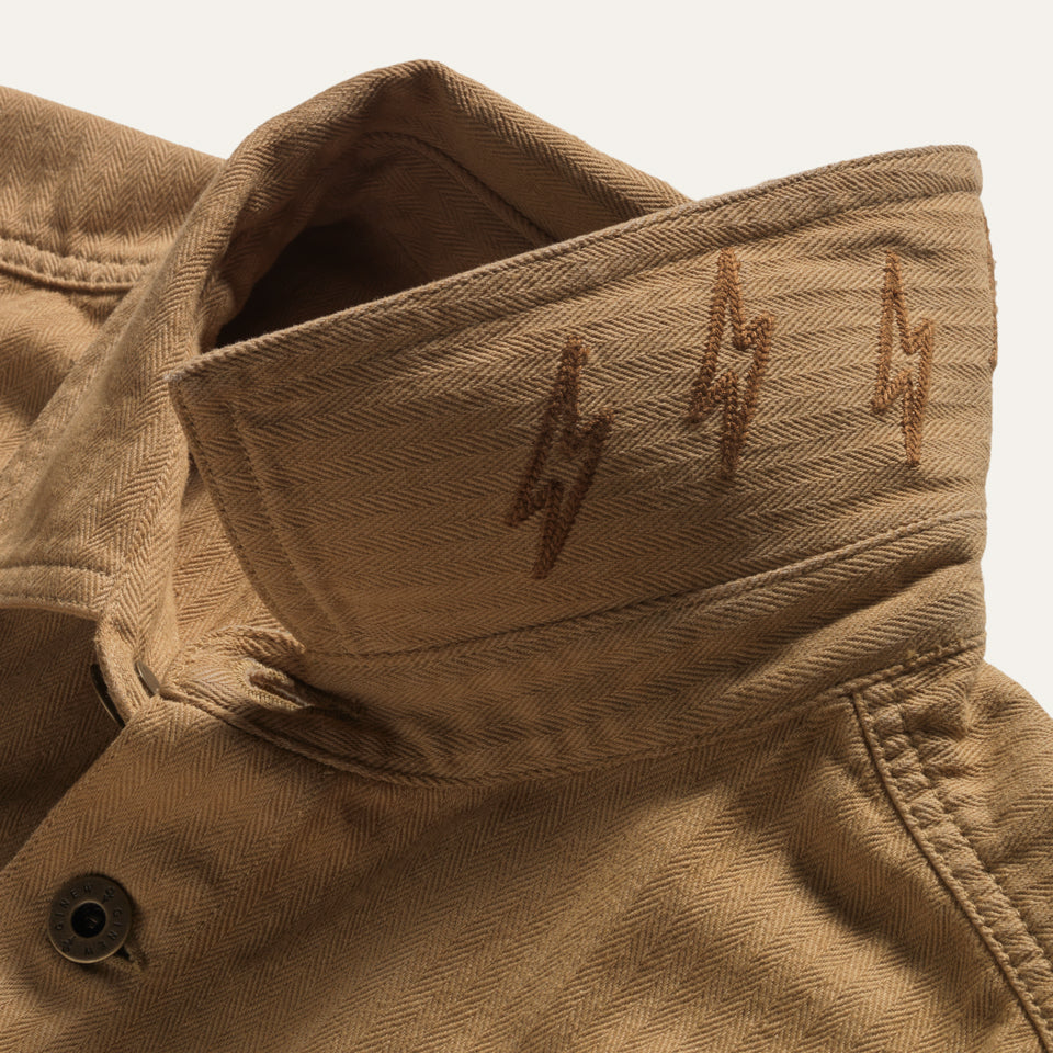 Lightning embroidery on tan saddle color cotton barn jacket male and female all gender with four pockets