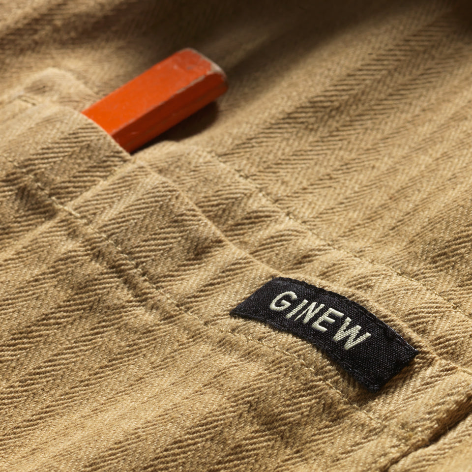 Close up of pocket on tan saddle color cotton barn jacket male and female all gender with four pockets