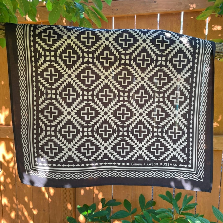 Hanging on branch, Native American Indigenous Artist designed cotton bandana by Ginew in black and natural white 