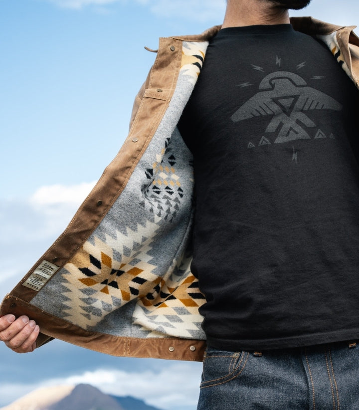 Black Native American Ojibwe Thunderbird t-shirt made by Indigenous Ginew on man hiking