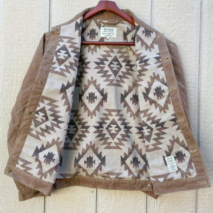 Opened version of Brown wax canvas rider coat lined in Native American brown and cream wool made by Indigenous owned Ginew