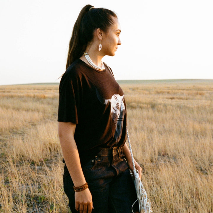 Indigenous Native American woman wearing Buffalo Bison Skull tee in Black and off white by Ginew