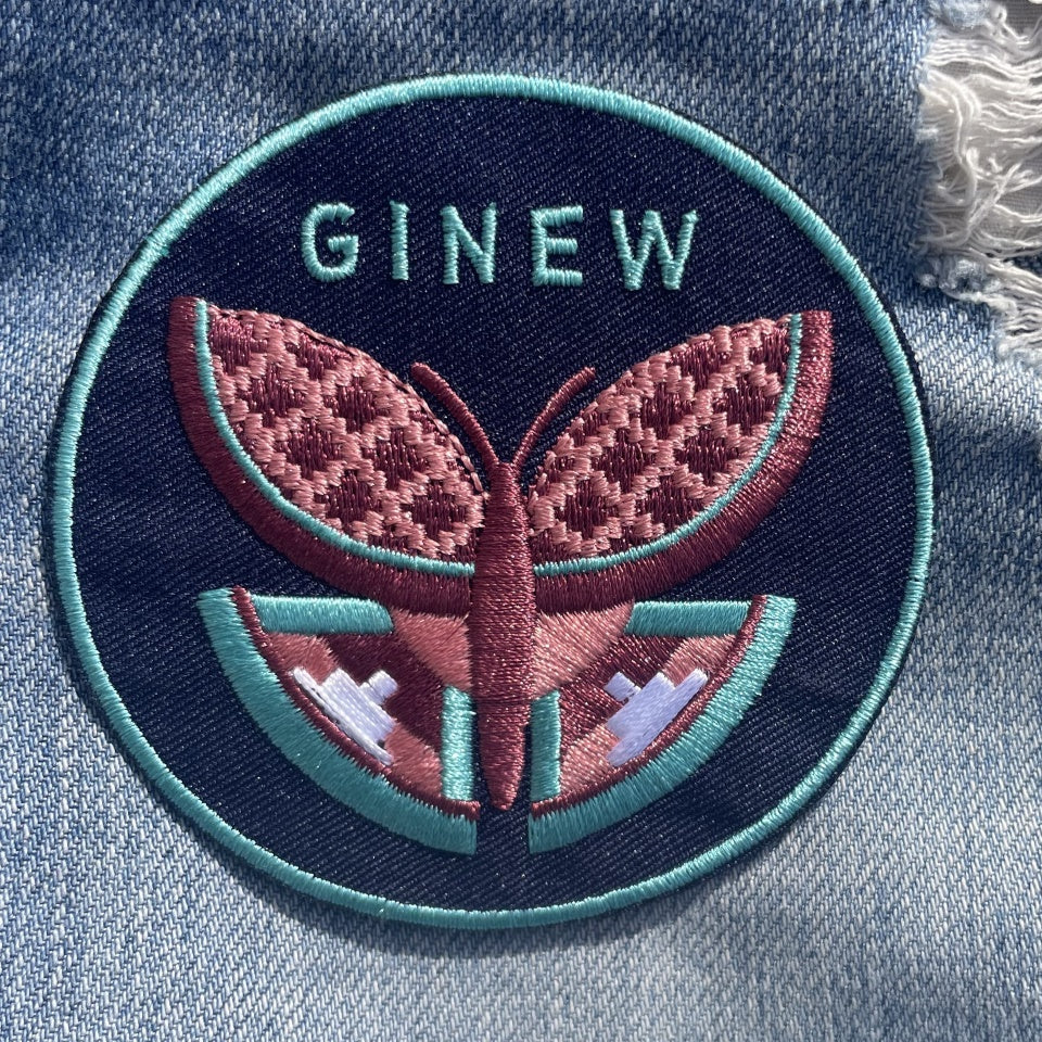 Mauve and seafoam green butterfly patch on torn denim with Ginew on top