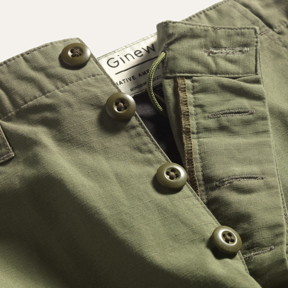 Detail view of four button fly on green Ginew Cargo Pants.
