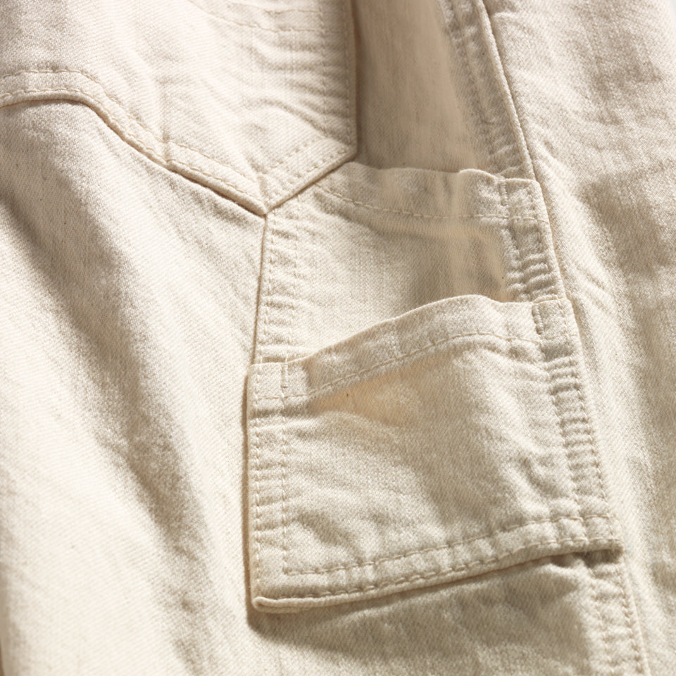 Close up of side pockets on Cream cotton cropped carpenter pants created by Native American Ginew