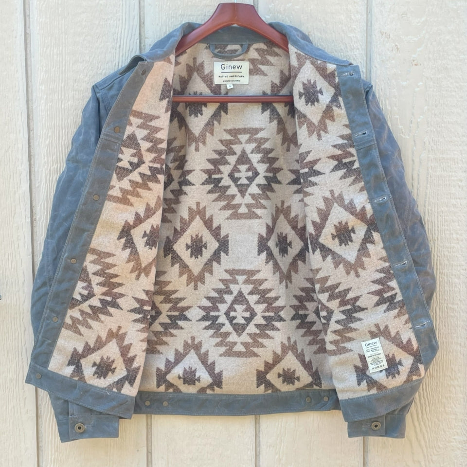 Lining on Grey silver charcoal wax canvas rider coat lined with  Native American design in  brown and cream wool interior made by Indigenous owned Ginew