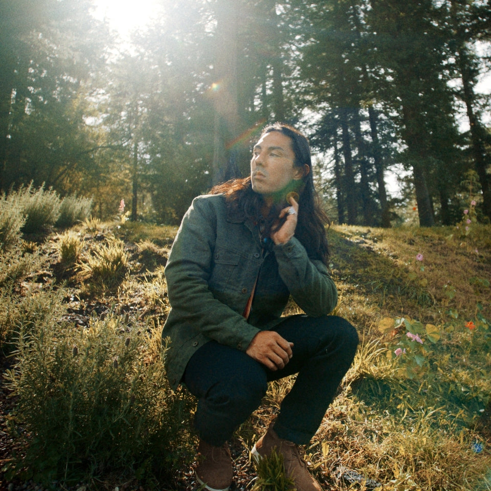 Native American wearing Charcoal grey rider coat lined with red and black Pendleton Walking Rock blanket lining 