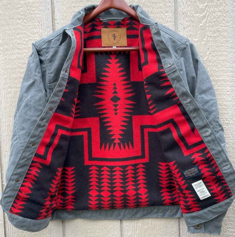 Lining showing on Ginew's Charcoal grey rider coat lined with red and black Pendleton Walking Rock blanket lining 