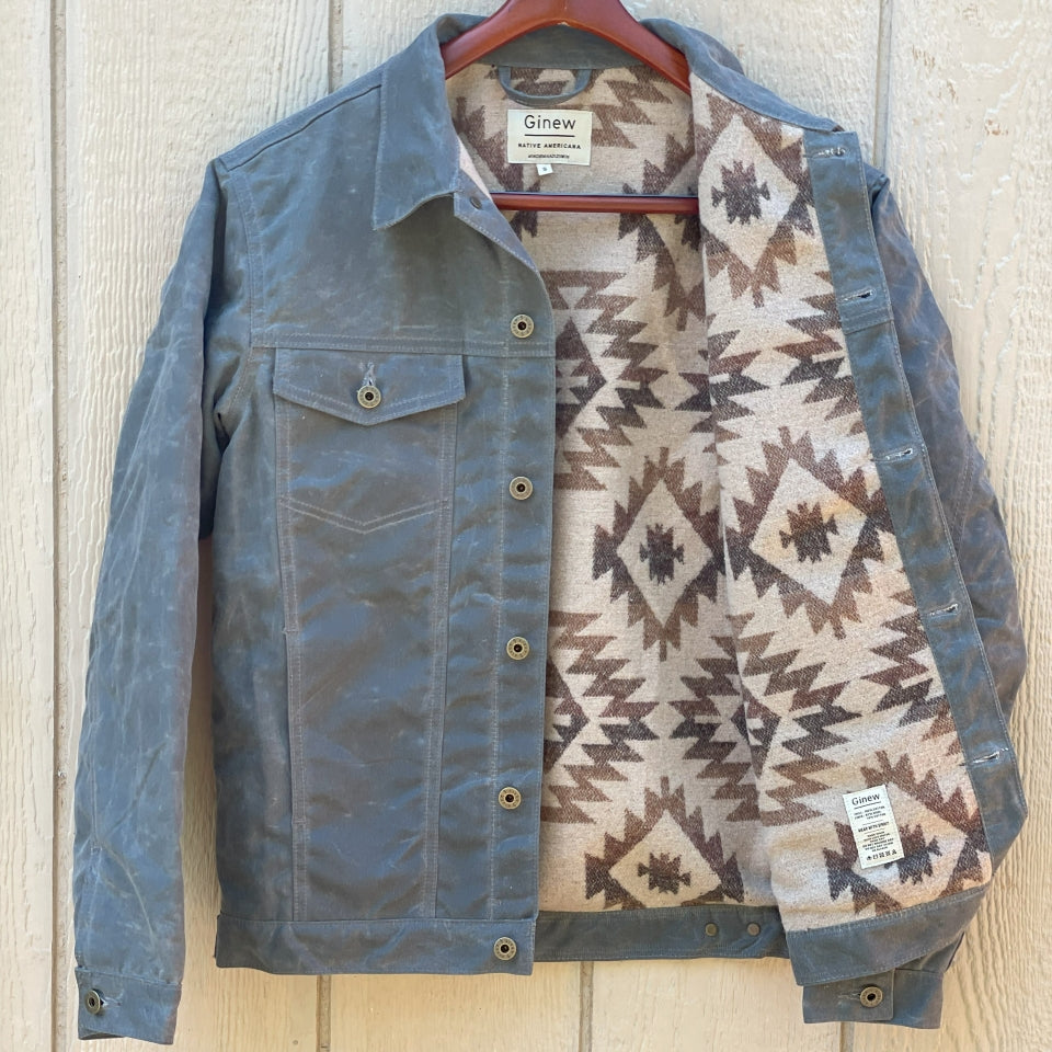 Grey silver charcoal wax canvas rider coat lined with  Native American design in  brown and cream wool interior made by Indigenous owned Ginew