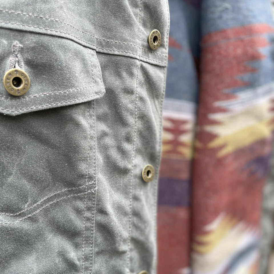 Pocket close up on Gray silver charcoal wool lined coat with a colorful Native American patterned lining by Ginew