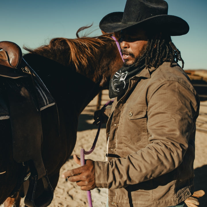 Farmer wearing brown made in USA wax canvas lined coat by Indigenous Native American Ginew 