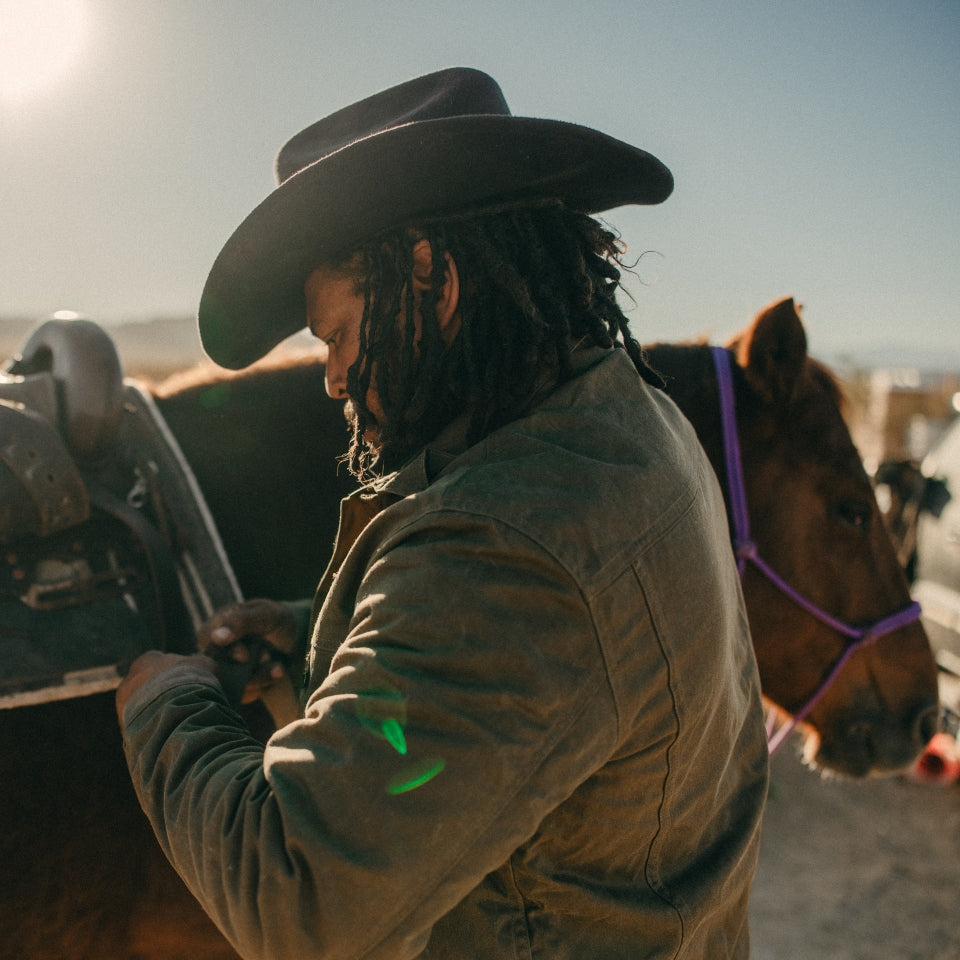 Rancher wearing made in USA Green wax canvas lined coat by Indigenous Ginew 