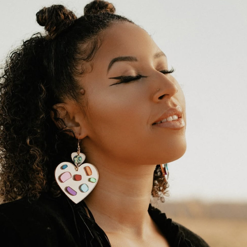 Indigenous designed heart earrings on woman
