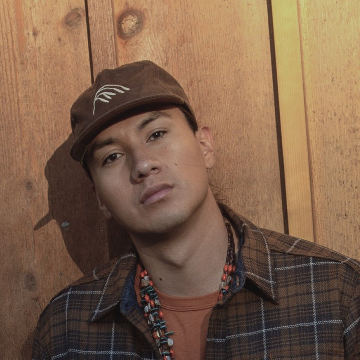 Native American Model Wearing Brown Plaid shirt and Wax Canvas brown hat with wild rice embroidery