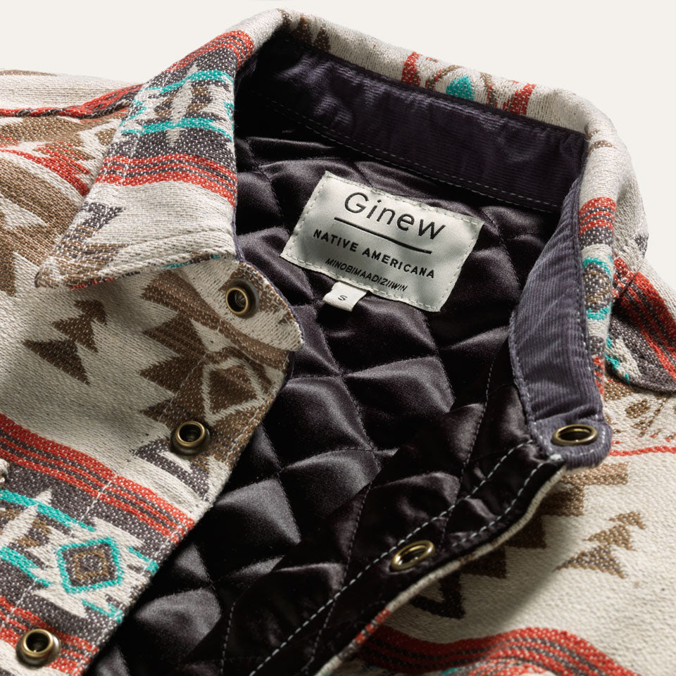 Close up of Ginew tag on Quilted Jacquard Shirt Jacket Burgandy and Turquoise and Tan made in USA