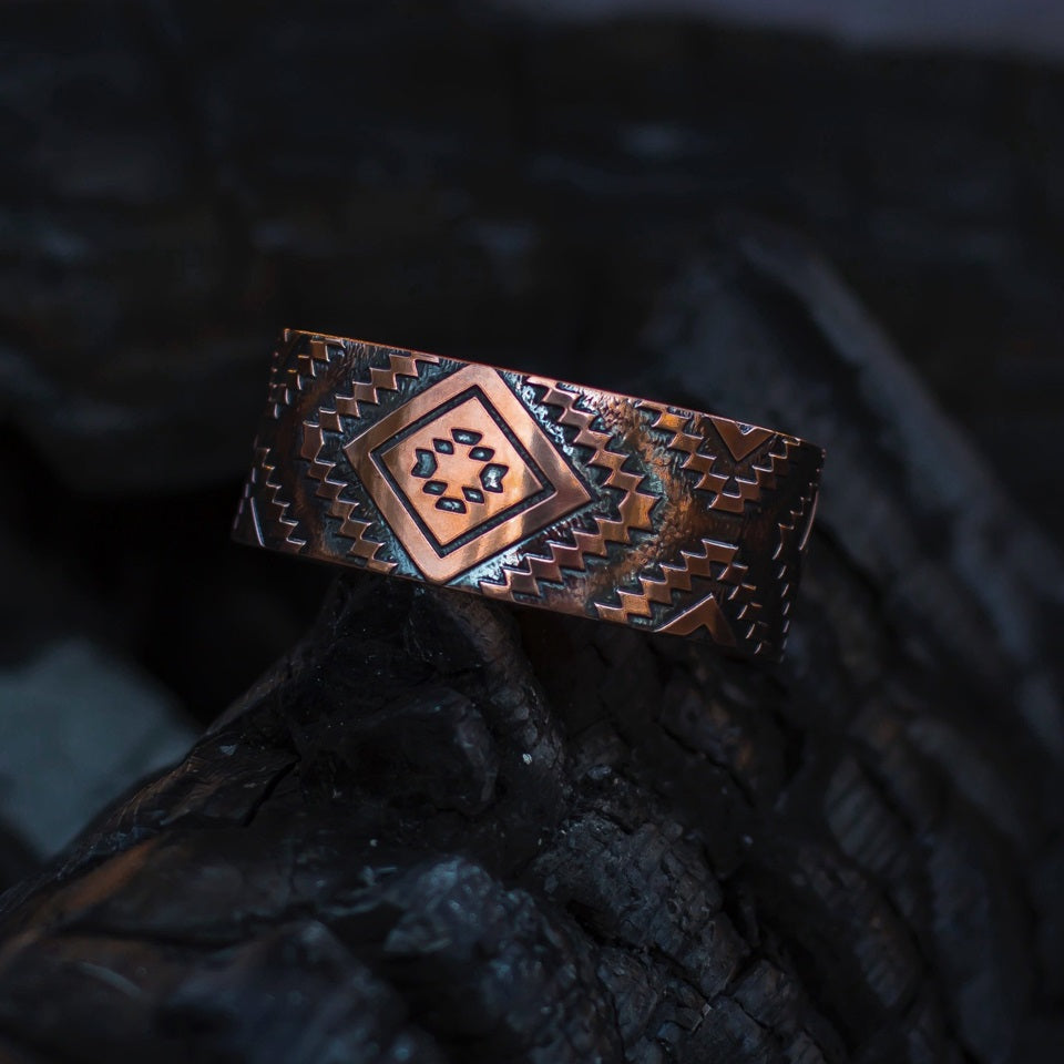 Native American hand crafted copper bracelet on black background