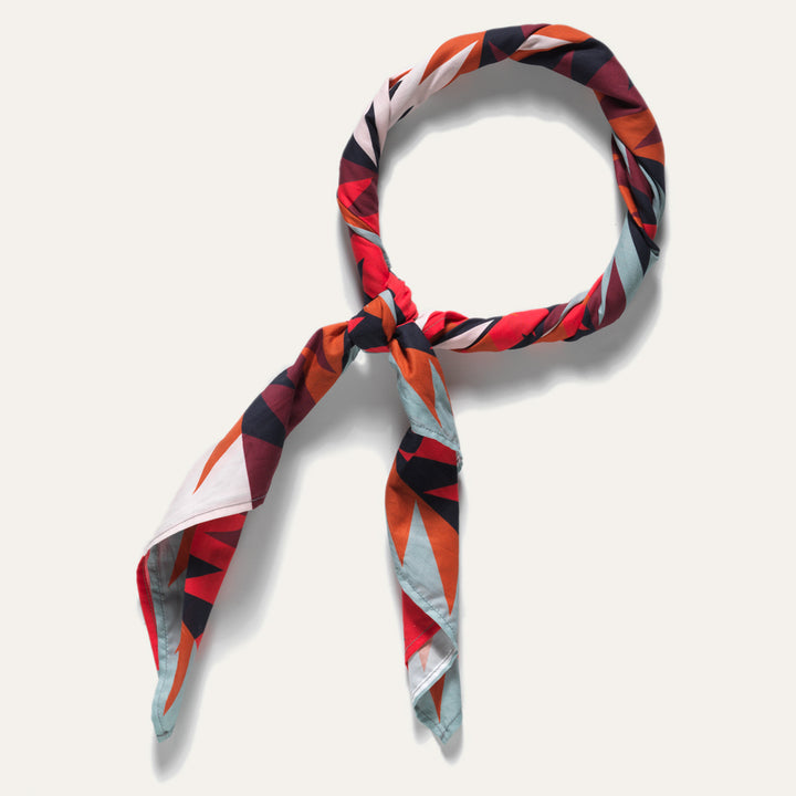 Rolled Native American designed wild rag bandana in red, blue, black and orange with Ginew tag