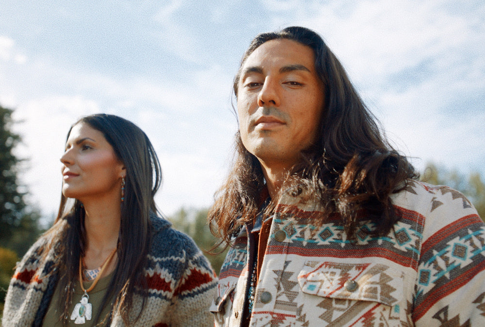 Native American models wearing Ginew handknit gray wool sweater and tan jacquard quilted shirt jacket