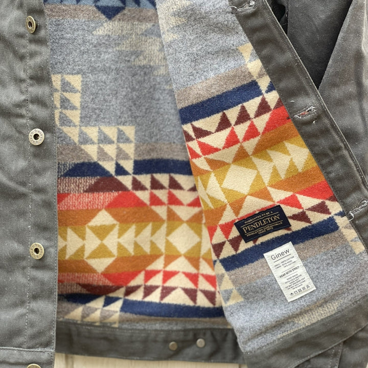 Care tag on Dark green herringbone rider coat with colorful wool lining by Pendleton and made in USA by Native American, Indigenous Ginew 
