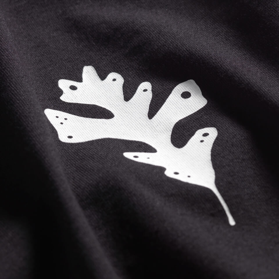 Close up of Black 100% cotton made in USA t-shirt with oak leaf in upper right