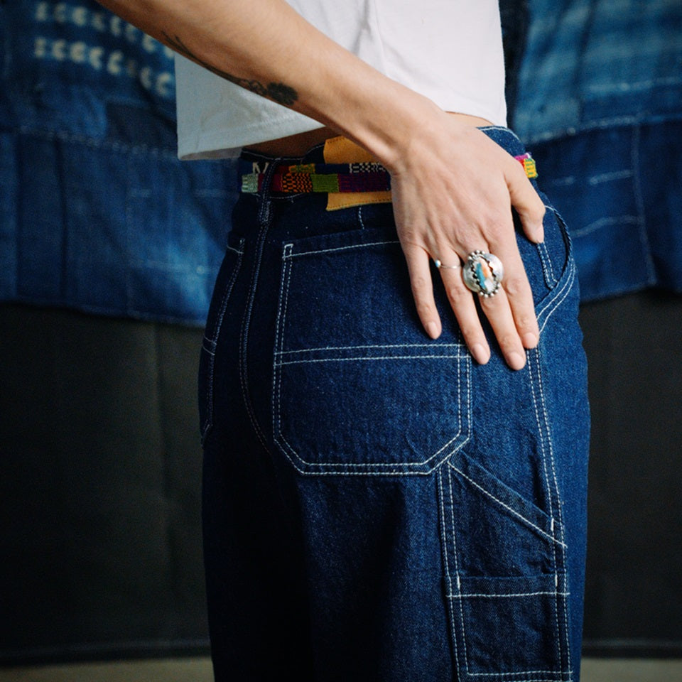 Side view of cropped indigo carpenter pants