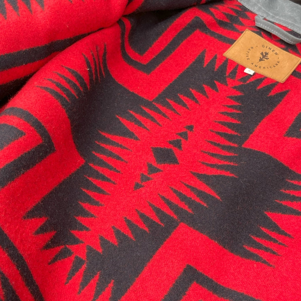 Close up of Charcoal grey rider coat lined with red and black Pendleton Walking Rock blanket lining 