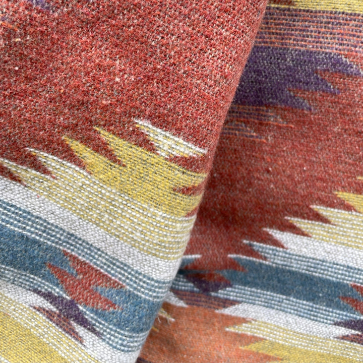 Lining close up on Gray silver charcoal wool lined coat with a colorful Native American patterned lining by Ginew