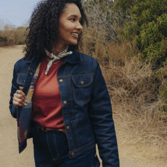 Deadstock denim lined wool coat on woman at coast