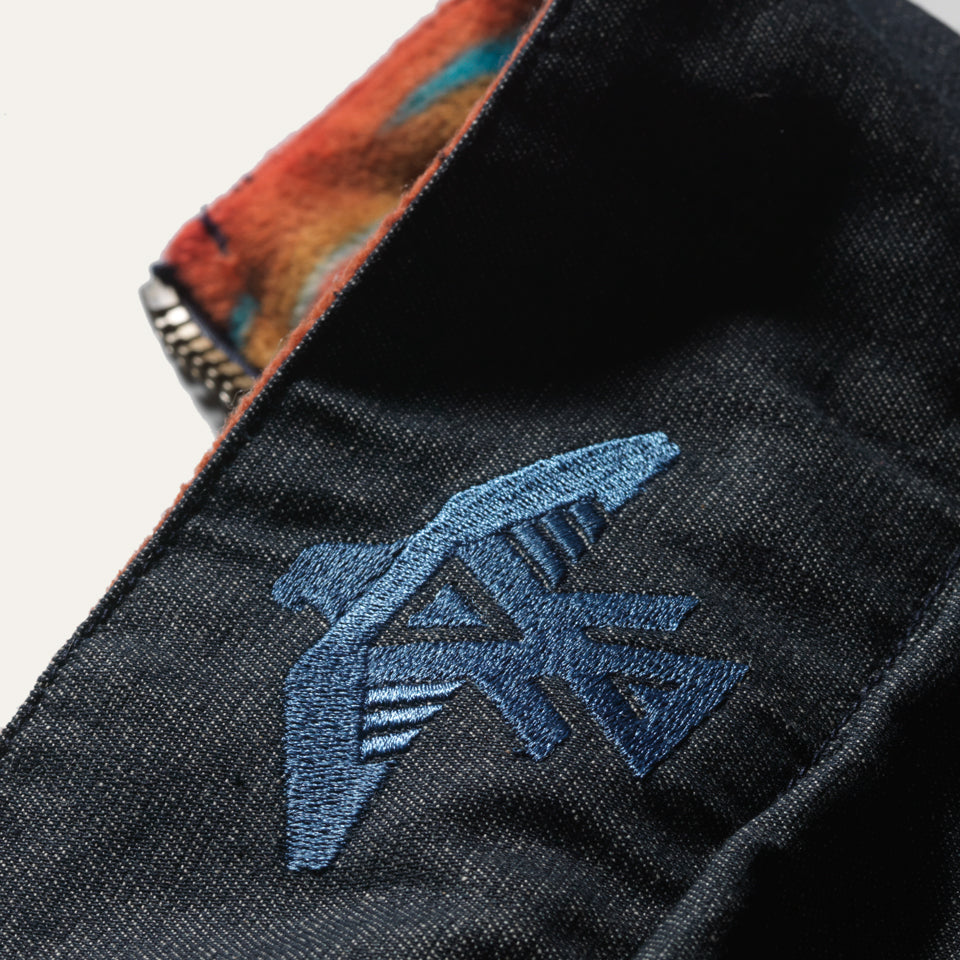 Close up of Thunderbird on Reversible faux down beat in denim and fleece by Ginew 