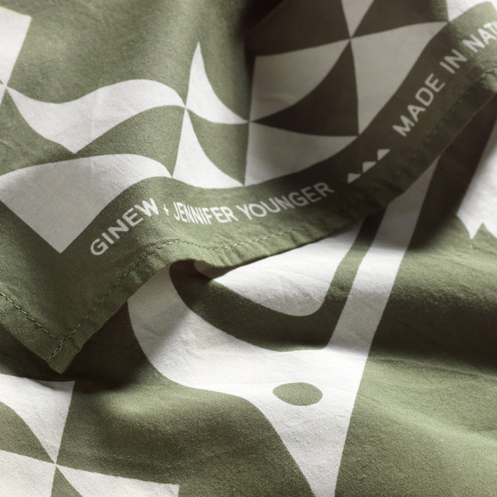 Native American designed bandana in green and cream with close up on Ginew + Jennifer Younger