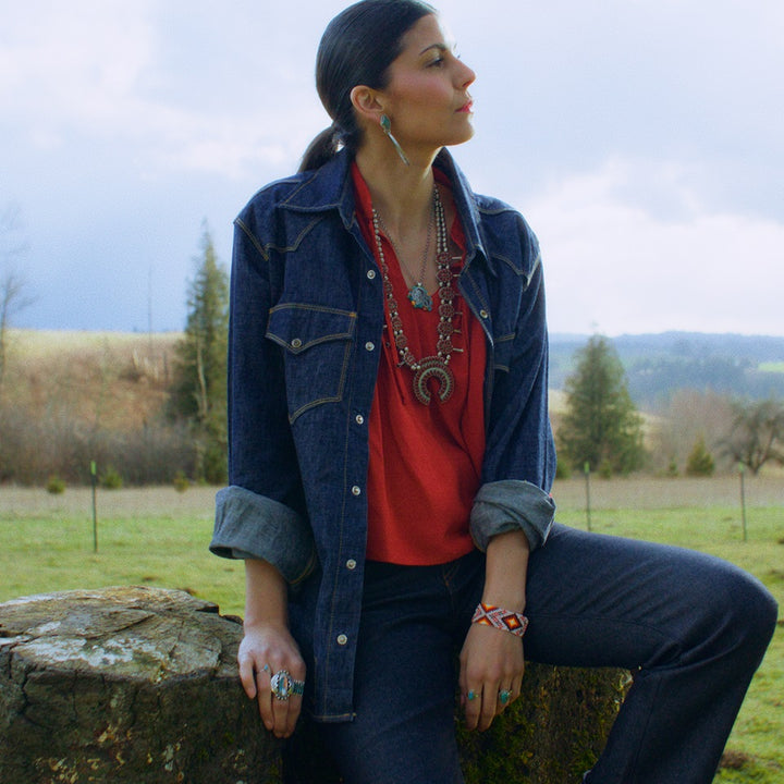 Red Ruffle shirt with Western denim shirt on Native American model in field