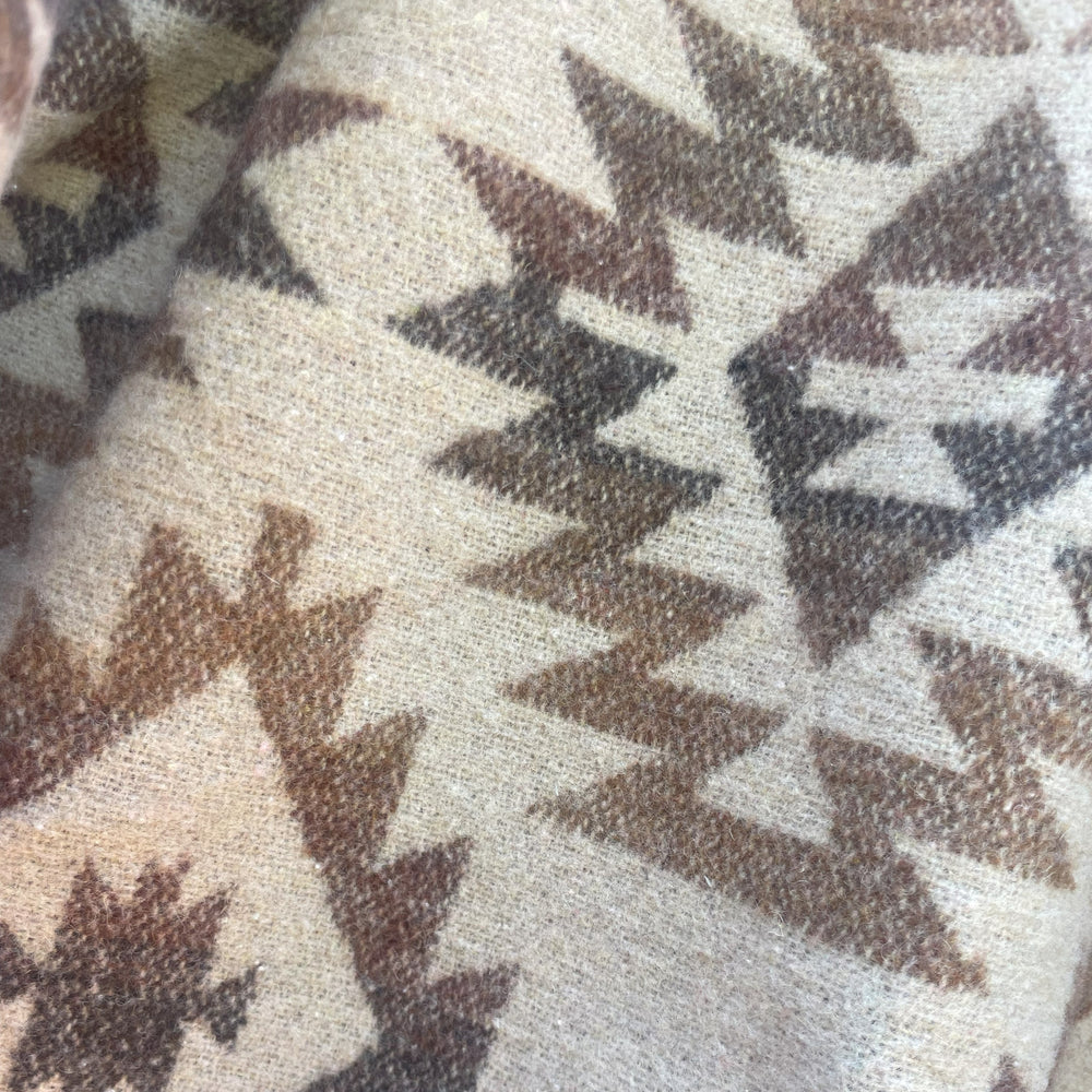 Close up on Brown wax canvas rider coat lined in Native American brown and cream wool made by Indigenous owned Ginew