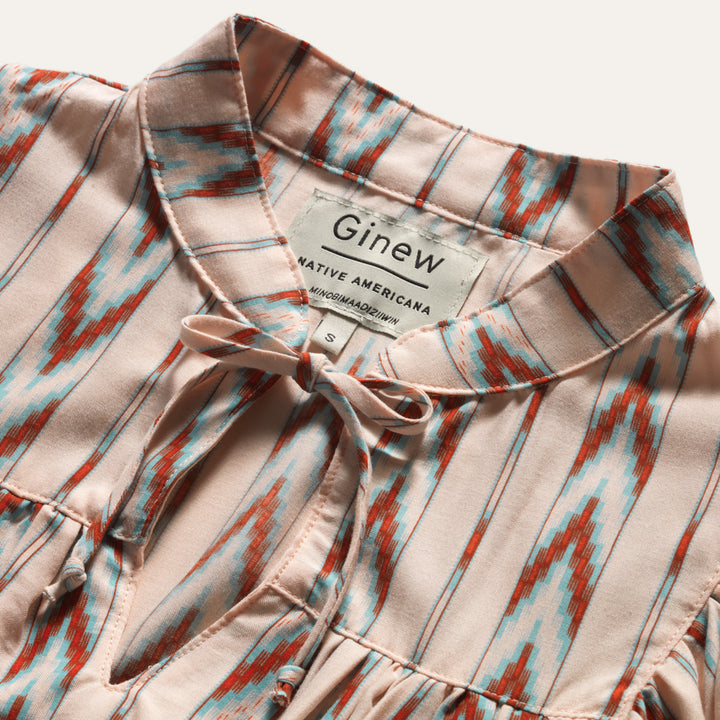 Close up of tie on front of Native American Ginew Stripe Ruffle shirt  in red, turquoise blue, cream 